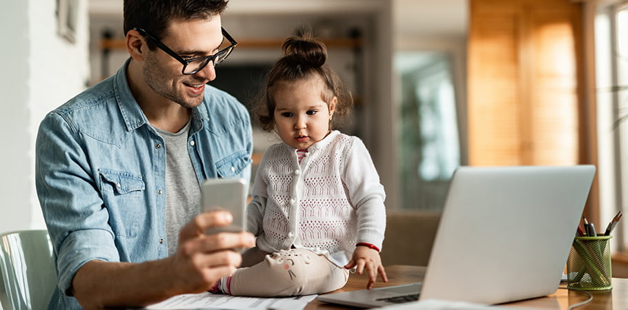 father working from home with daughter